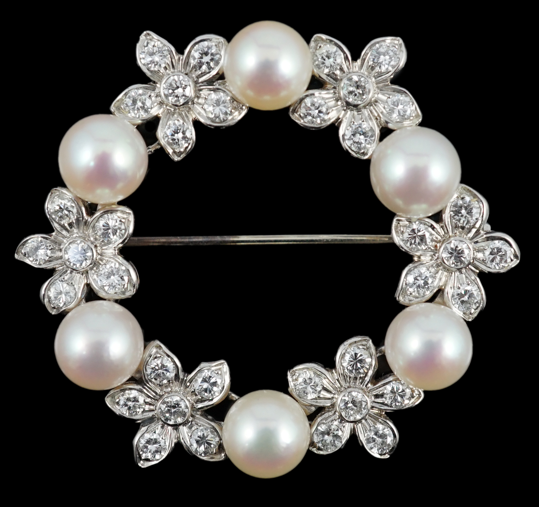 A late 20th century white gold cultured pearl and diamond cluster set openwork circular brooch